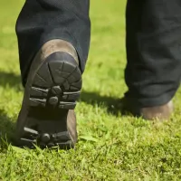 tech walking on the grass