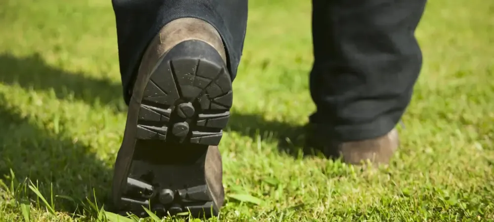 tech walking on the grass