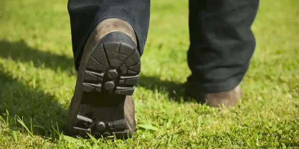 tech walking on the grass