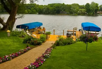 walkway with flowers to lake
